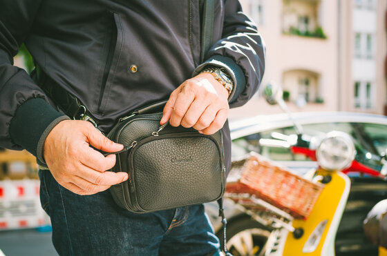 Nahaufnahme der Oberwerth KIKI aus schwarzem Leder im Alltagseinsatz, getragen als kompakte Crossbody-Tasche